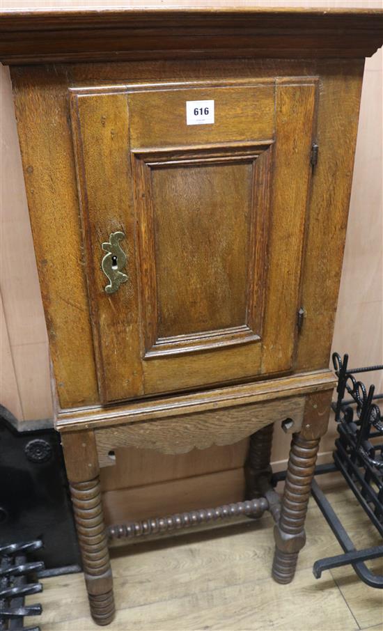 An 18th century French oak cupboard on a later stand, H.129cm